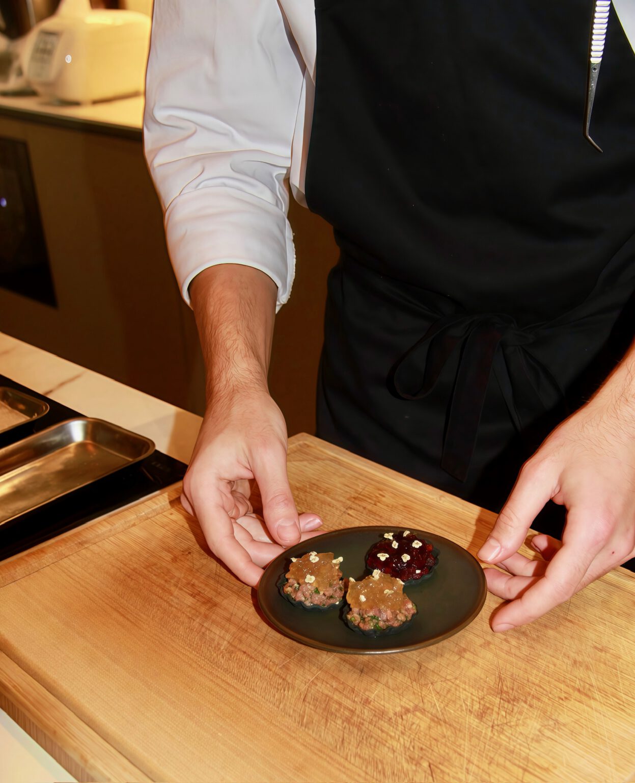 A Pr&eacute;mices chef at work in a villa kitchen during a cooking class