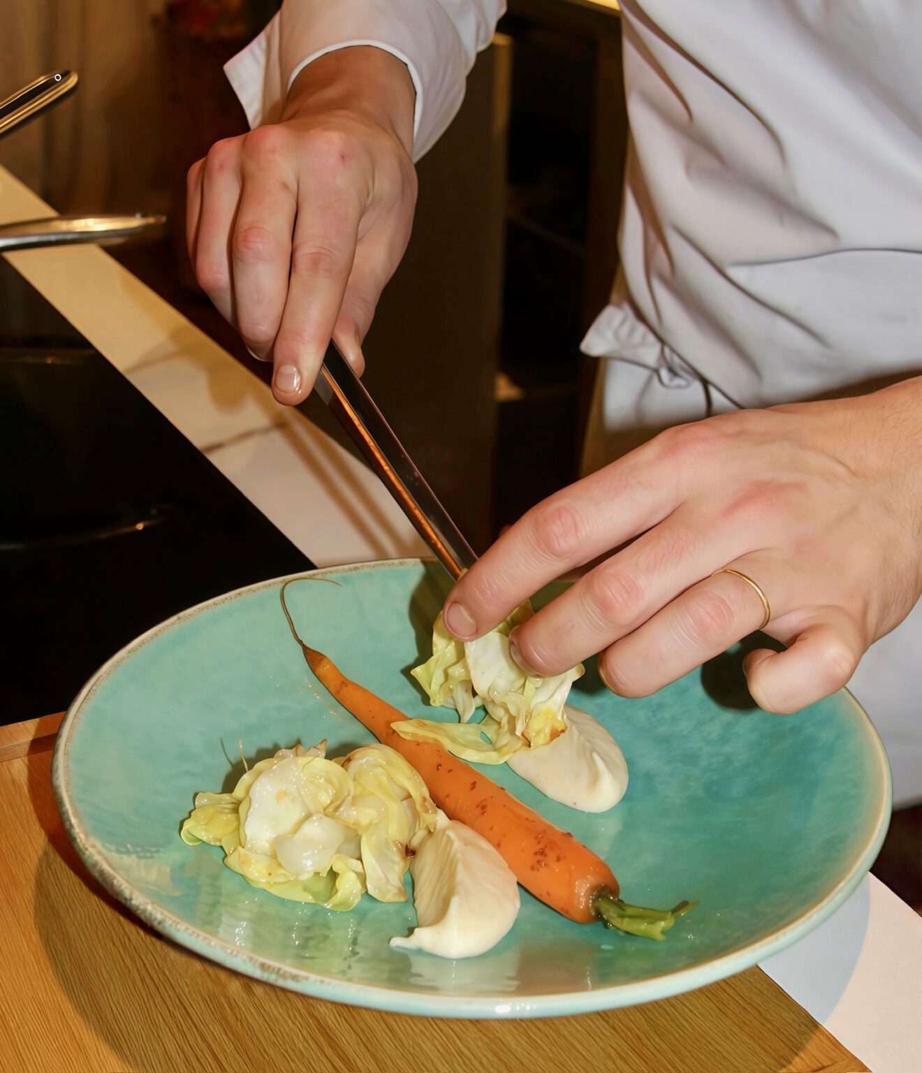 A Pr&eacute;mices chef at work in a villa kitchen during a cooking class